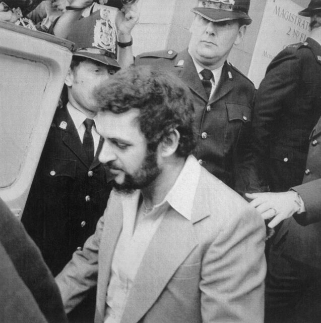 Peter Sutcliffe walking to police car