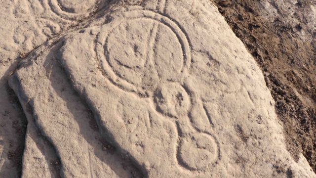 Images such as the mirror are carved into the stone