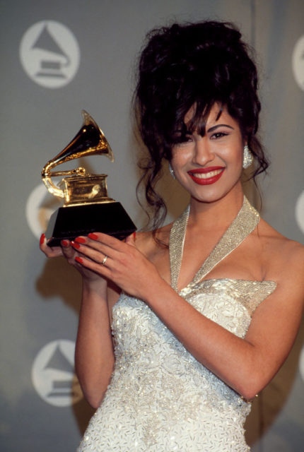 Selena holding her Grammy Award