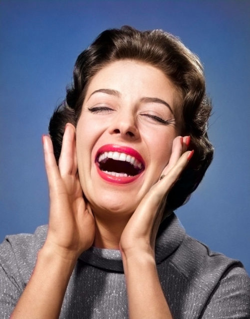 Woman smiling with her hands around her face