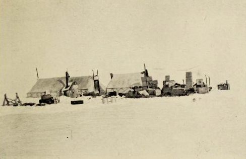 The camp at Wrangel Island with two large tents. Ada Blackjack can be seen standing in front of a tent in the distance.