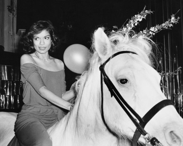 Diana Jagger riding a white horse