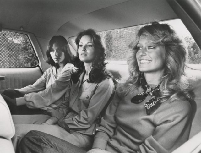 Jaclyn Smith, Kate Jackson, and Farrah Fawcett in the backseat of a car while filming "Charlie's Angels".