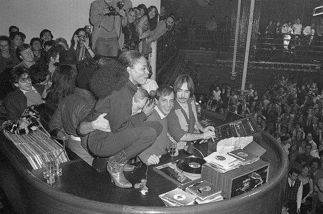 Diana Ross squatting atop the disc jockey booth