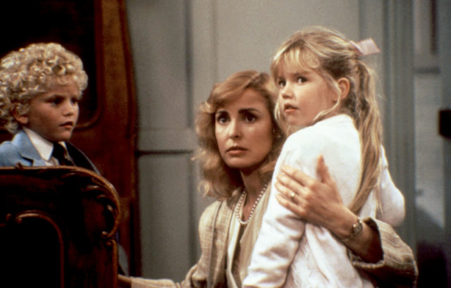 The mother embraces her two children in a scene from the 1987 film adaptation