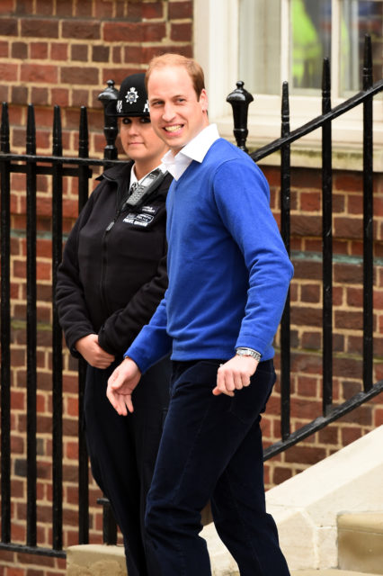 Prince William walking by a police officer