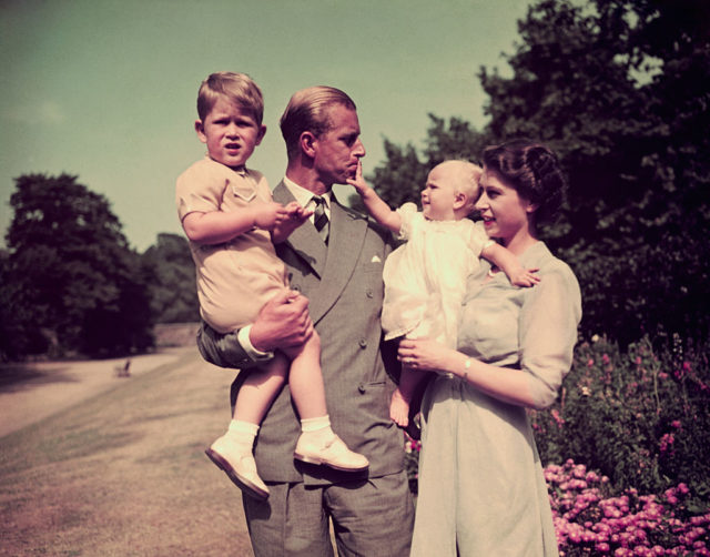 Queen Elizabeth and Price Philip hold their children Prince Charles and Princess Anne