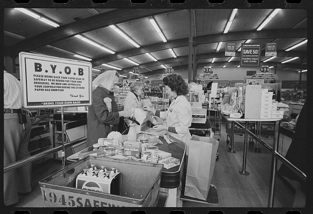 A sign asking customers to bring their own bag while at the Safeway checkout in 1974.