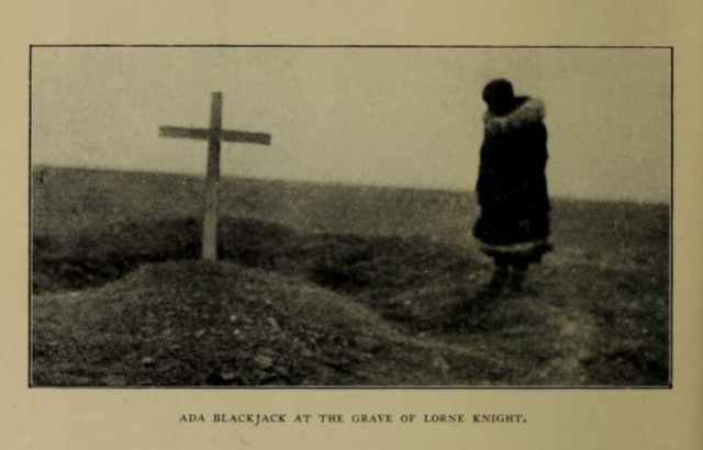 A photograph of Ada Blackjack at the grave of Lorne Knight. 
