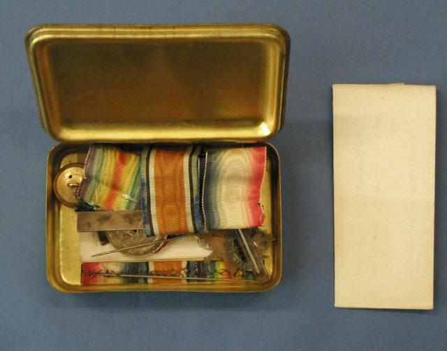 Princess Mary gift box with a card from Princess Mary filled with other personal belongings; received by Sergeant GWL Thomson, 3-143, New Zealand Medical corps, 1NZEF, WW1. (Photo Credit: Auckland Museum / Wikimedia Commons CC BY 4.0)