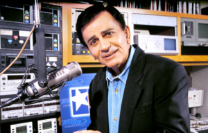 Casey Kasem sitting behind a radio microphone