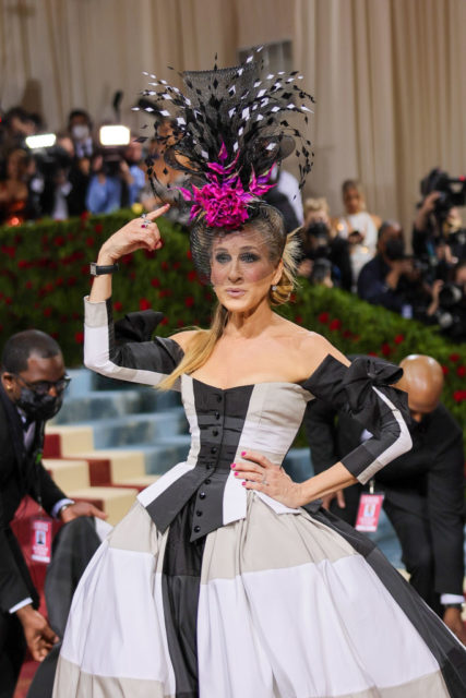 Actress Sarah Jessica Parker on the MET Gala Red Carpet in a stunning gown and large headpeice.