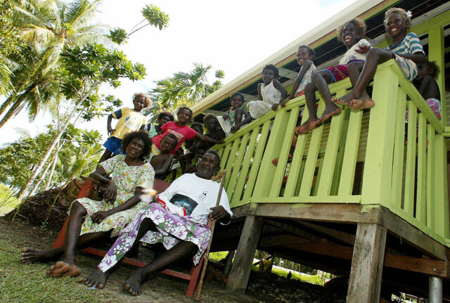 Biuka Gasa sits in front of a family gathering