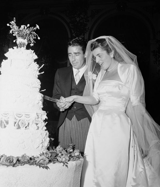 A bride and groom cut their wedding cake