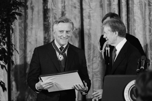 black and white phto of Kirk Douglas receiving the Medal of Freedom