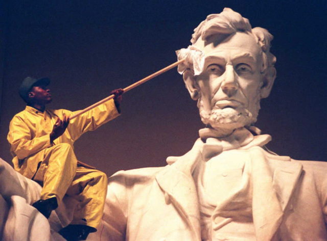 US National Park Service worker cleaning the statue of Abraham Lincoln