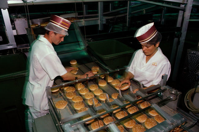 Two McDonald's workers making hamburger buns