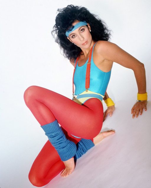 Cher in bright colored workout clothes and leg warmers