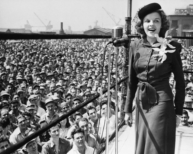 Judy Garland performing in front of a large crowd