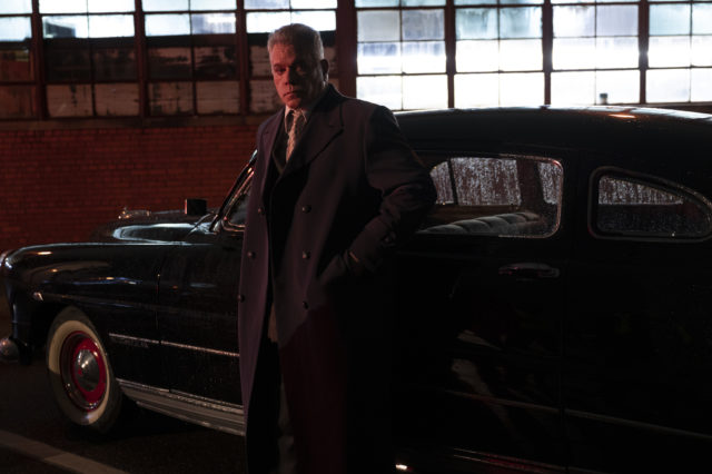 Ray Liotta leans against a car in gritty crime drama No Sudden Move.