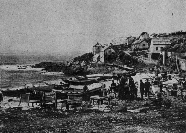 Black and white image of a beachside loaded with boats in St Pierre