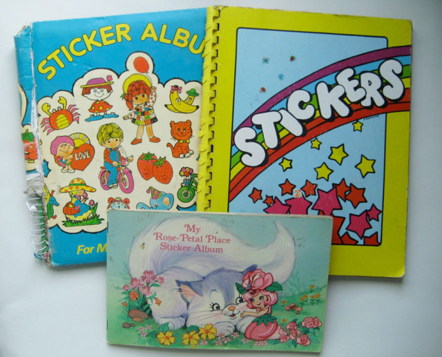 Three sticker books stacked together