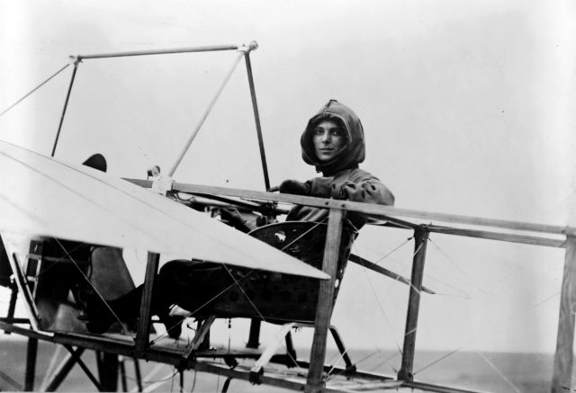 Harriet Quimby sitting on the wing of a Moisant monoplane