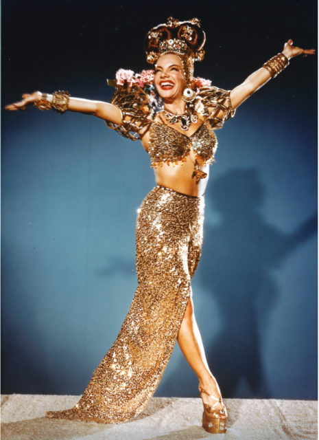 Carmen Miranda in a beautiful gold costume and hat