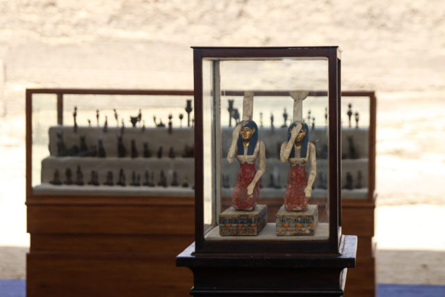 Multiple statuettes on display, with two larger ones in front