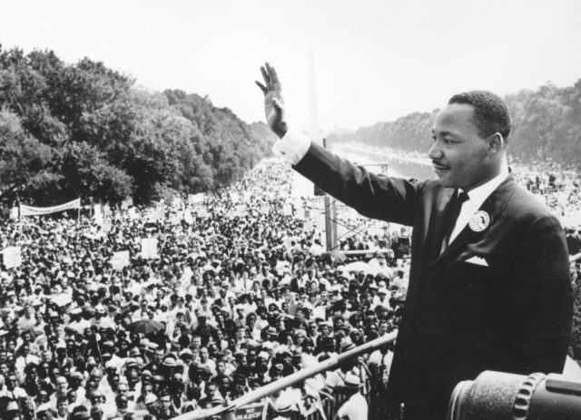 Martin Luther King Jr. waving at the crowd