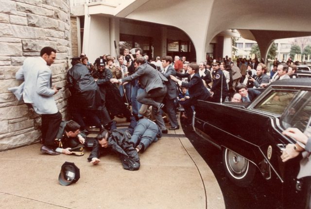 Chaos as a crowd of people look in horror following the Reagan assassination attempt