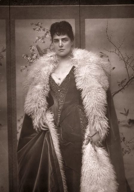 Portrait of Jennie Churchill in extravagant gown and fur trimmed cape.