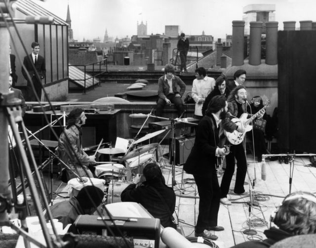 The Beatles performing on a rooftop