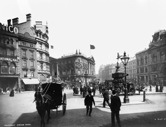 Pedestrians walk about Piccadilly Circus in 1894
