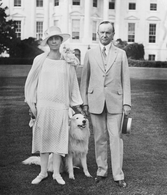 President Calvin Coolidge and his wife Grace standing in front of the White House