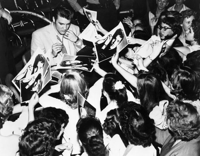 Elvis signing autographs