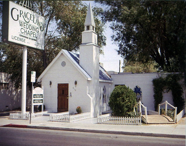 front of white wedding chapel building