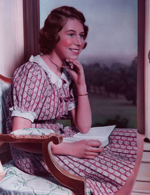 Teenage Princess Elizabeth poses while reading a book.