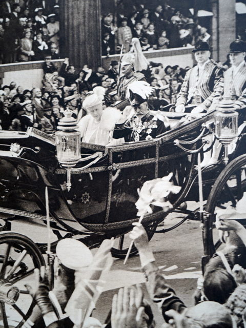 King George V and Queen Consort Mary of Teck in a carriage with people watching from the street