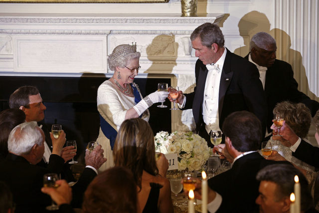Queen Elizabeth II and George W. Bush toasting wine glasses