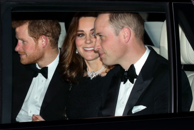 Kate Middleton sitting between Prince Harry and Prince William in a car