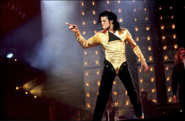 michael jackson on stage in gold pointing finger