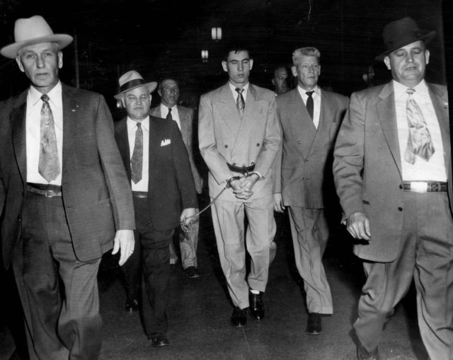 John Gilbert "Jack" Graham surrounded by plain-clothes guards