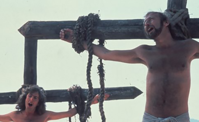 Eric Idle and Graham Chapman sing a song while crucified. 