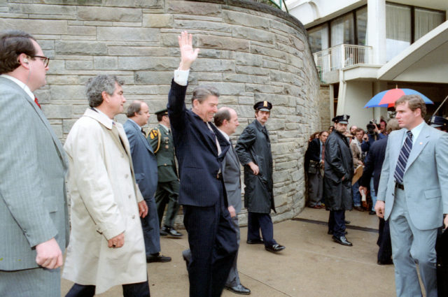 Ronald Reagan waves to crowds outside the Hilton Hotel before the assassination attempt