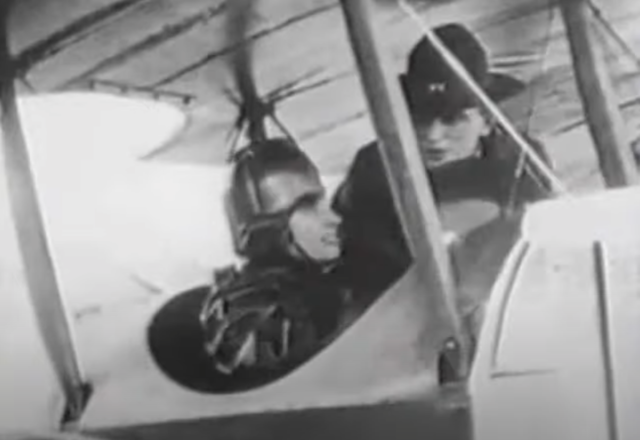 Helen Keller in plane with man behind her