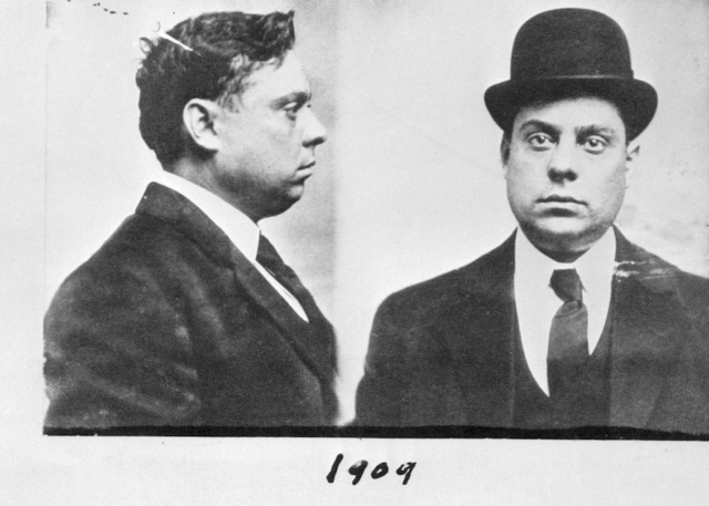 Mug shot of man in suit and top hat