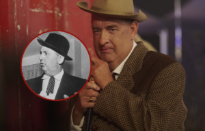 Coloured movie still of Tom Hanks dressed as Tom Parker wearing a suit and a fedora with a bubble showing a black and white picture of Tom Parker in a suit and fedora.