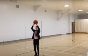 Man playing basketball in a suit
