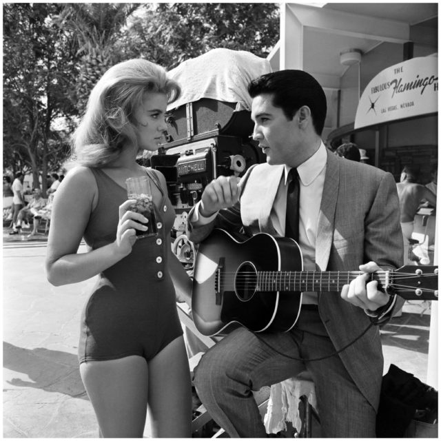 Elvis holds a guitar while Ann-Margaret holds a drink